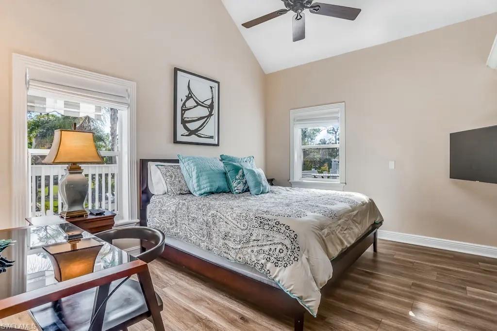 6941 Hunters Road Naples, FL 34109 - Photo 14 of 48 a bedroom with a bed and wooden floor