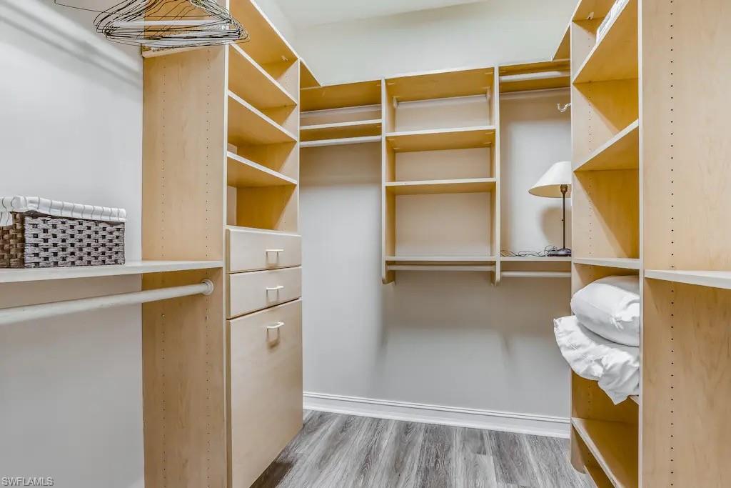 6941 Hunters Road Naples, FL 34109 - Photo 16 of 48 a view of walk in closet with empty racks