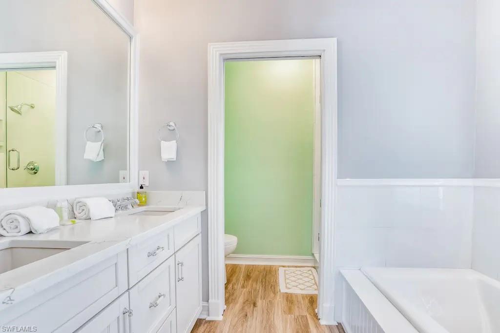 6941 Hunters Road Naples, FL 34109 - Photo 17 of 48 a bathroom with a granite countertop sink and a mirror