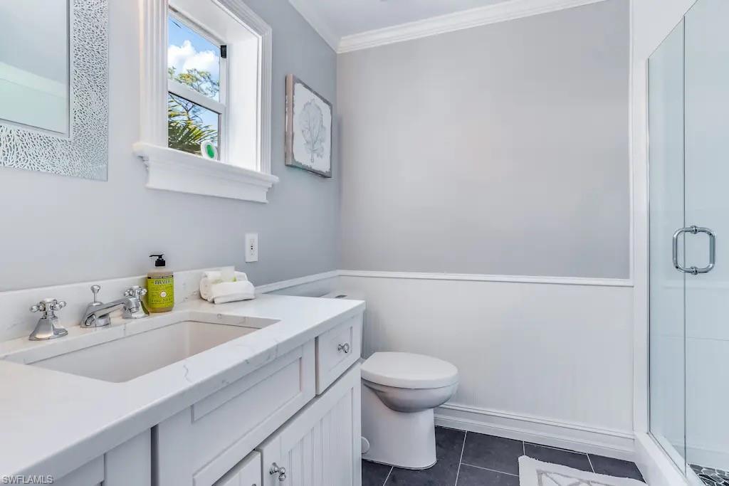 6941 Hunters Road Naples, FL 34109 - Photo 20 of 48 a bathroom with a sink vanity and toilet