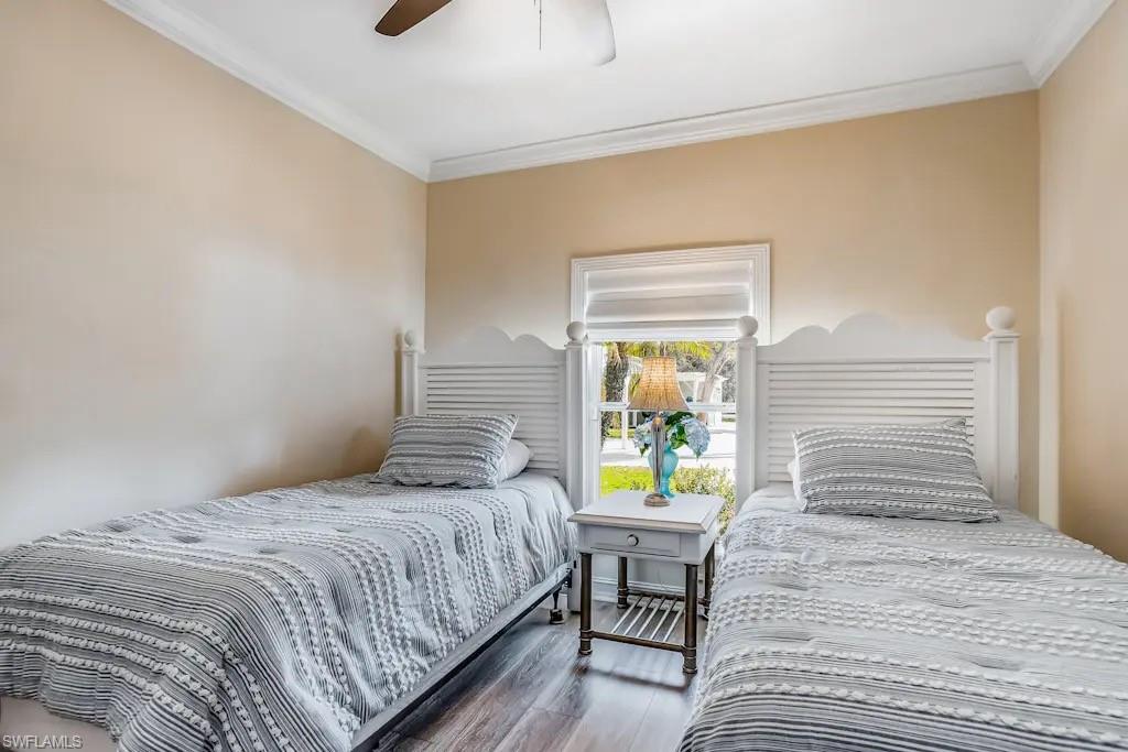 6941 Hunters Road Naples, FL 34109 - Photo 22 of 48 a bedroom with a bed and a window