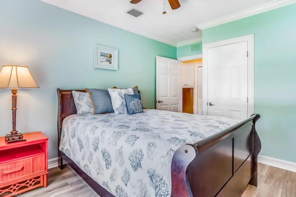 6941 Hunters Road Naples, FL 34109 - Photo 24 of 48 a bedroom with bed and wooden floor