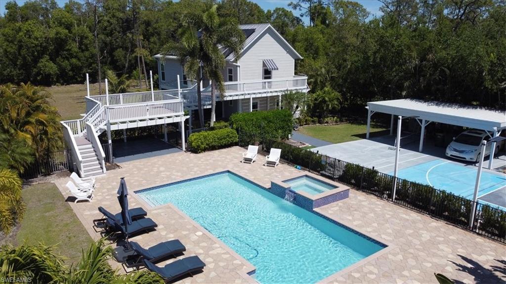 6941 Hunters Road Naples, FL 34109 - Photo 28 of 48 a view of a house with backyard and sitting area