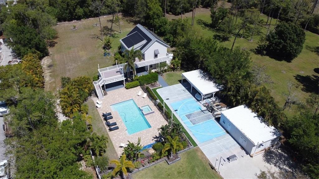 6941 Hunters Road Naples, FL 34109 - Photo 3 of 48 an aerial view of a house with a yard