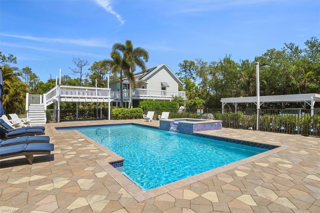 6941 Hunters Road Naples, FL 34109 - Photo 32 of 48 a view of swimming pool with seating space and garden view