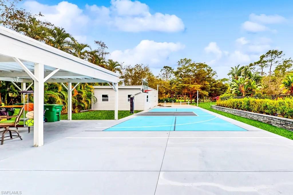6941 Hunters Road Naples, FL 34109 - Photo 34 of 48 a view of a swimming pool with an outdoor space