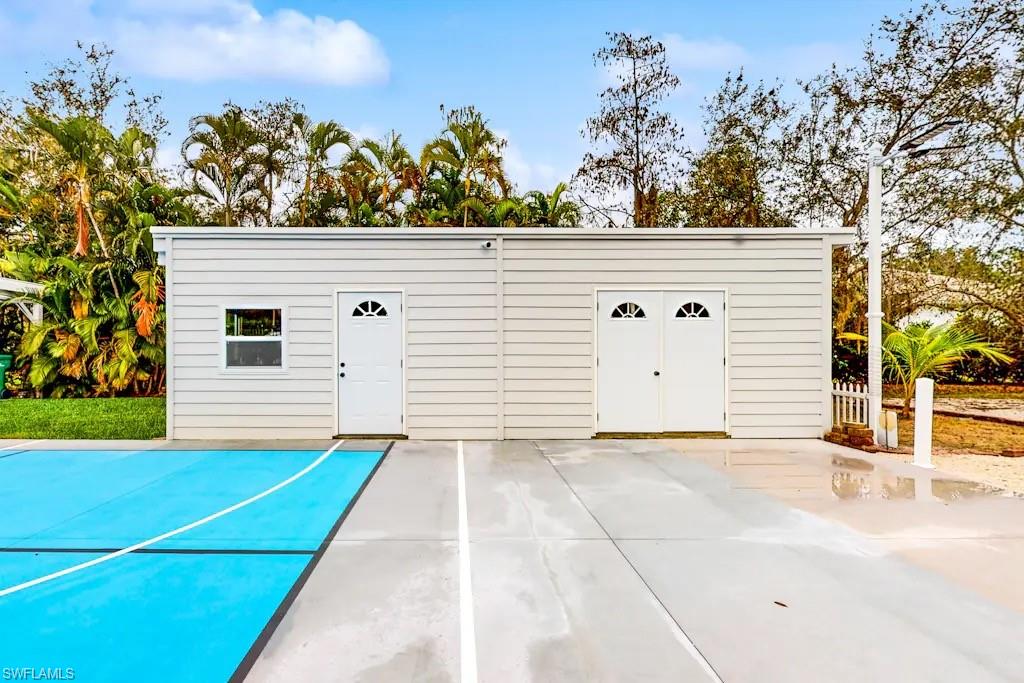 6941 Hunters Road Naples, FL 34109 - Photo 35 of 48 a view of a house with a backyard