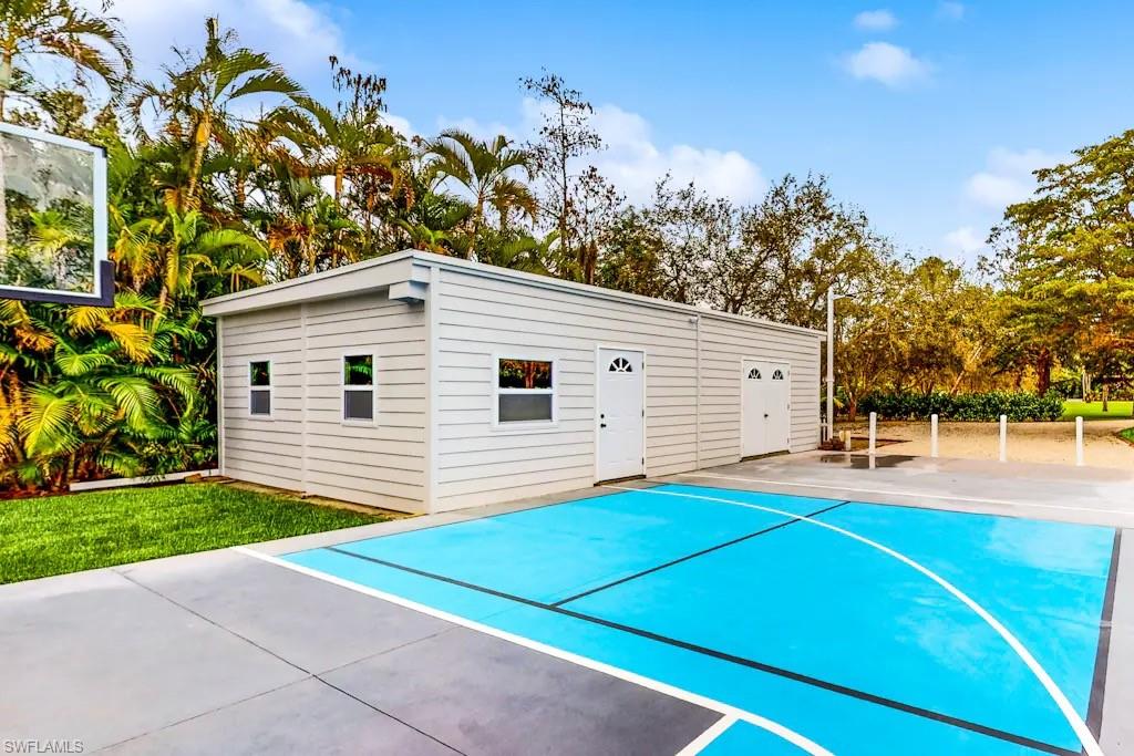 6941 Hunters Road Naples, FL 34109 - Photo 38 of 48 a front view of a house with a yard and garage
