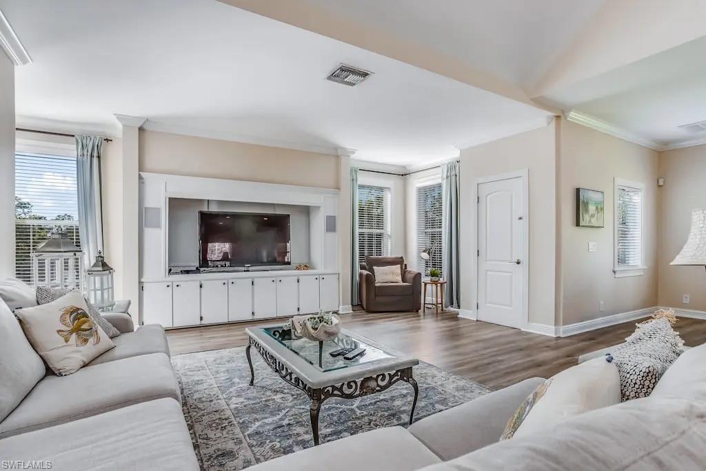 6941 Hunters Road Naples, FL 34109 - Photo 4 of 48 a living room with furniture and a flat screen tv