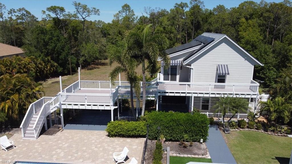6941 Hunters Road Naples, FL 34109 - Photo 42 of 48 a front view of a house with a yard and garage