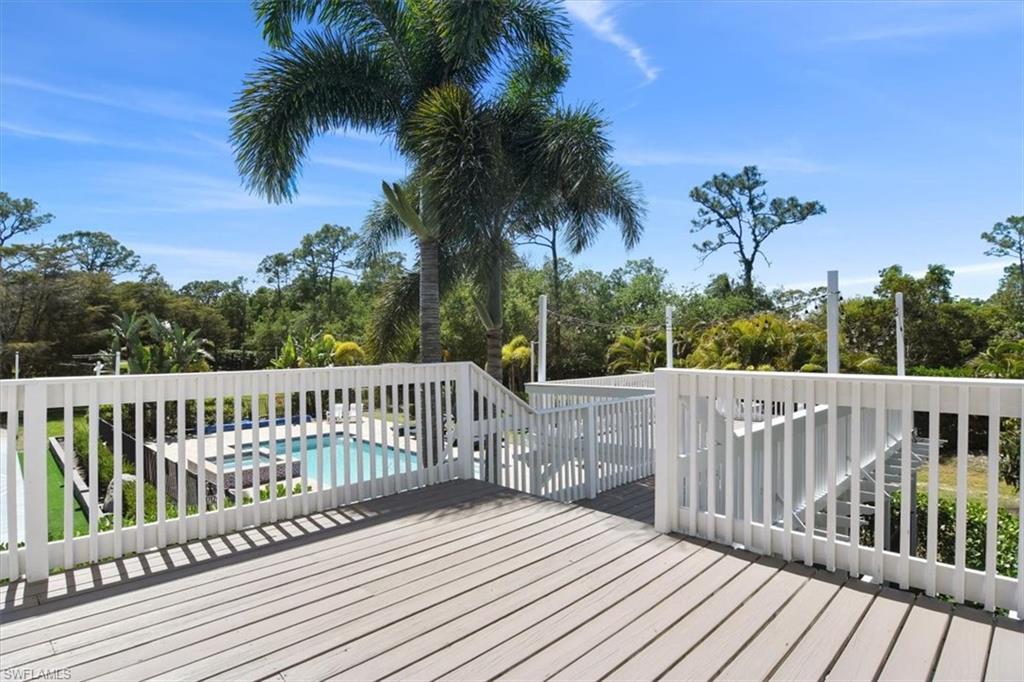 6941 Hunters Road Naples, FL 34109 - Photo 43 of 48 a view of balcony with wooden floor and fence