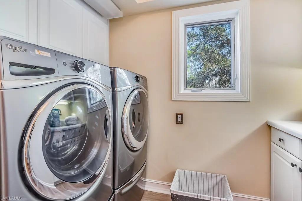 6941 Hunters Road Naples, FL 34109 - Photo 47 of 48 a utility room with dryer and washer