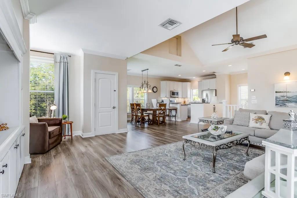 6941 Hunters Road Naples, FL 34109 - Photo 5 of 48 a living room with furniture and wooden floor