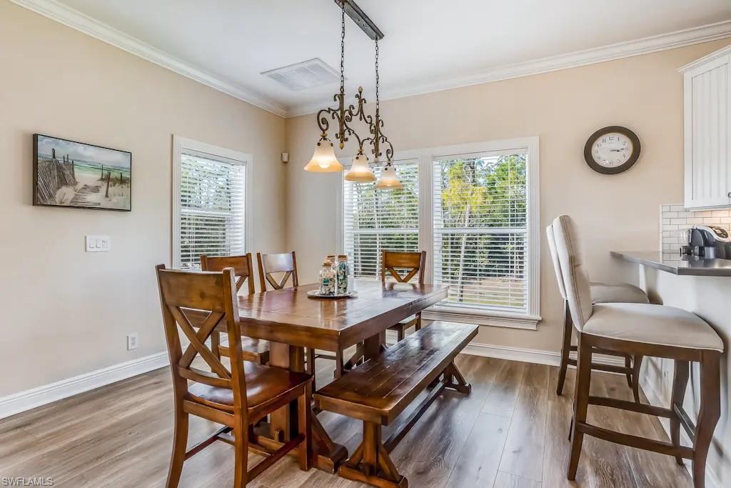 6941 Hunters Road Naples, FL 34109 - Photo 9 of 48 a view of a dining room with furniture window and outside view
