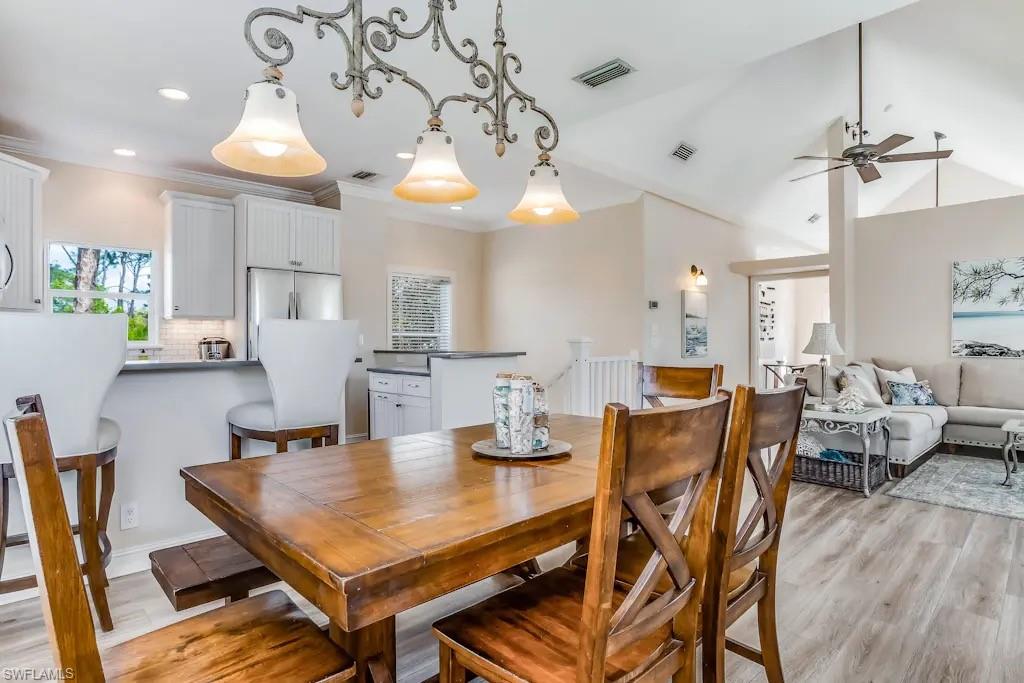 6941 Hunters Road Naples, FL 34109 - Photo 10 of 48 a view of a dining room with furniture