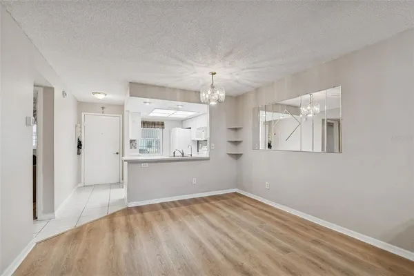 a kitchen with granite countertop a sink cabinets stainless steel appliances and a window