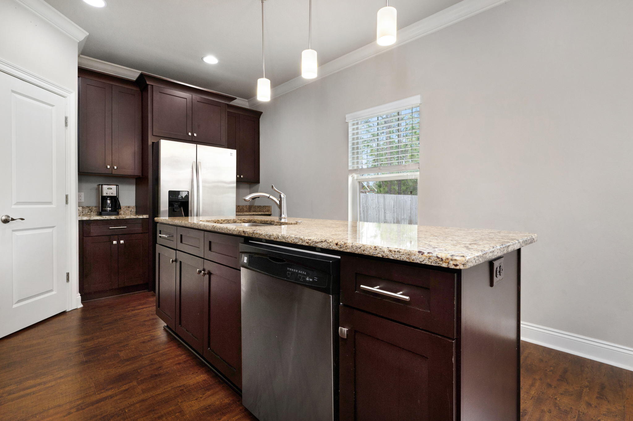 9018 Timber Lane Navarre, FL 32566 - Photo 12 of 39 a kitchen with granite countertop a sink cabinets and wooden floor