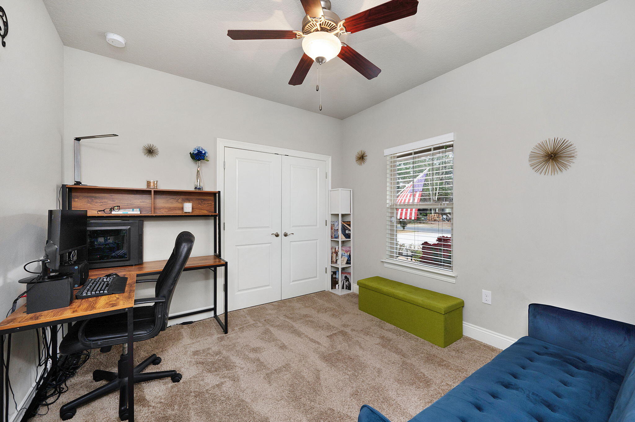 9018 Timber Lane Navarre, FL 32566 - Photo 23 of 39 a bedroom with a bed and a chandelier