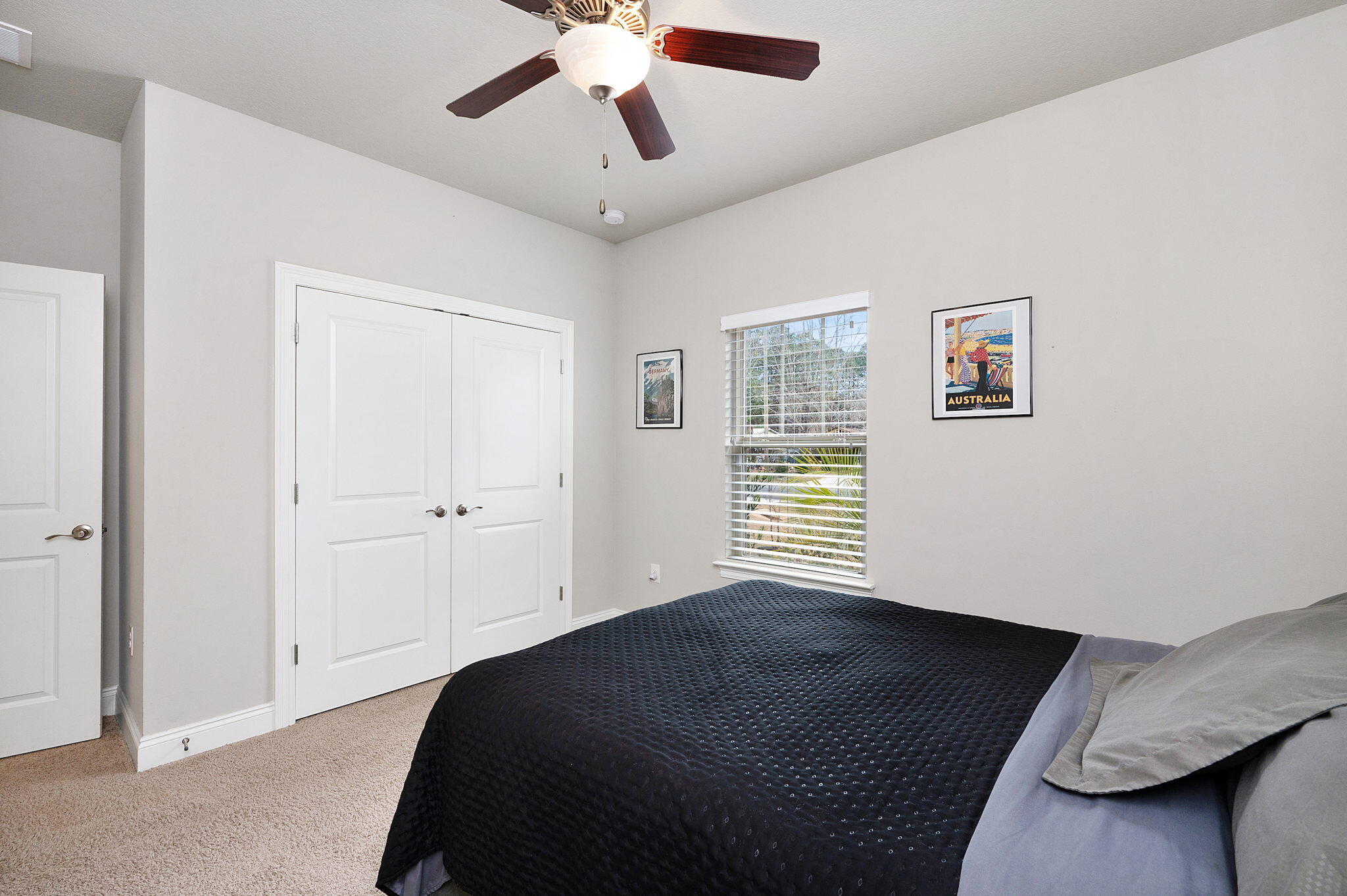 9018 Timber Lane Navarre, FL 32566 - Photo 28 of 39 a bedroom with a bed and a chandelier