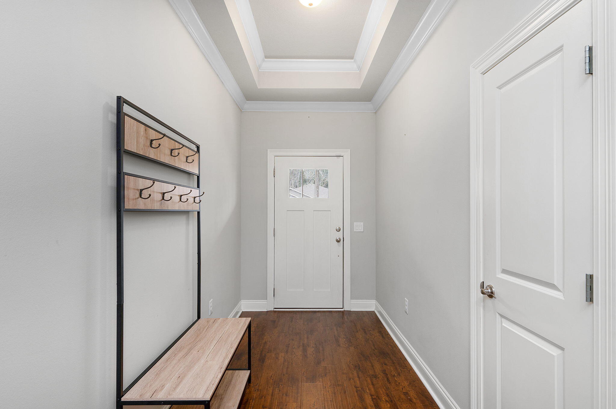 9018 Timber Lane Navarre, FL 32566 - Photo 3 of 39 a view of a hallway with wooden floor