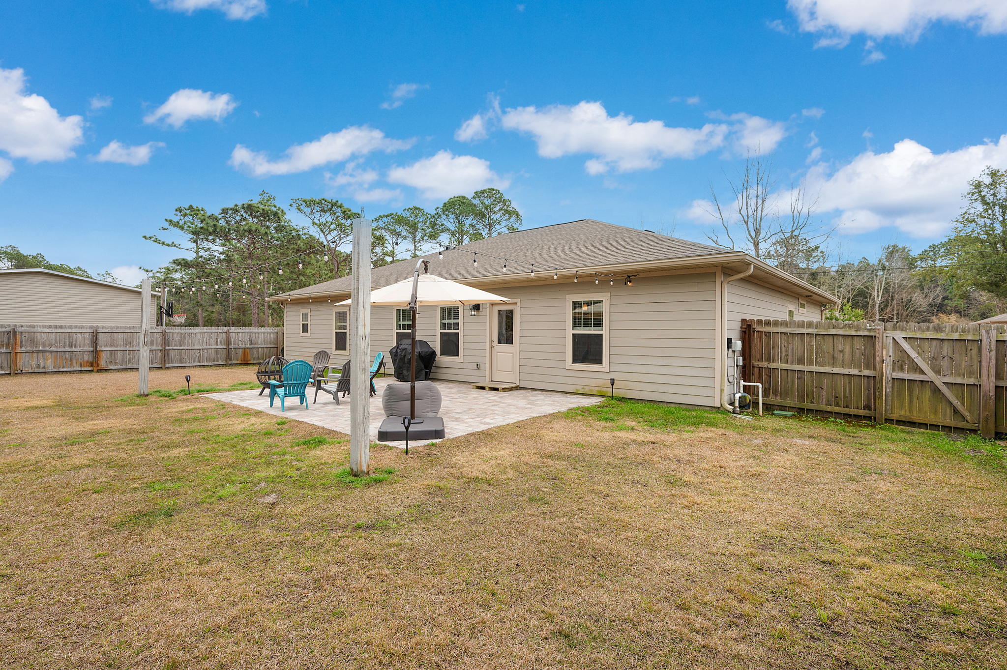 9018 Timber Lane Navarre, FL 32566 - Photo 31 of 39 a view of a house with backyard and sitting area