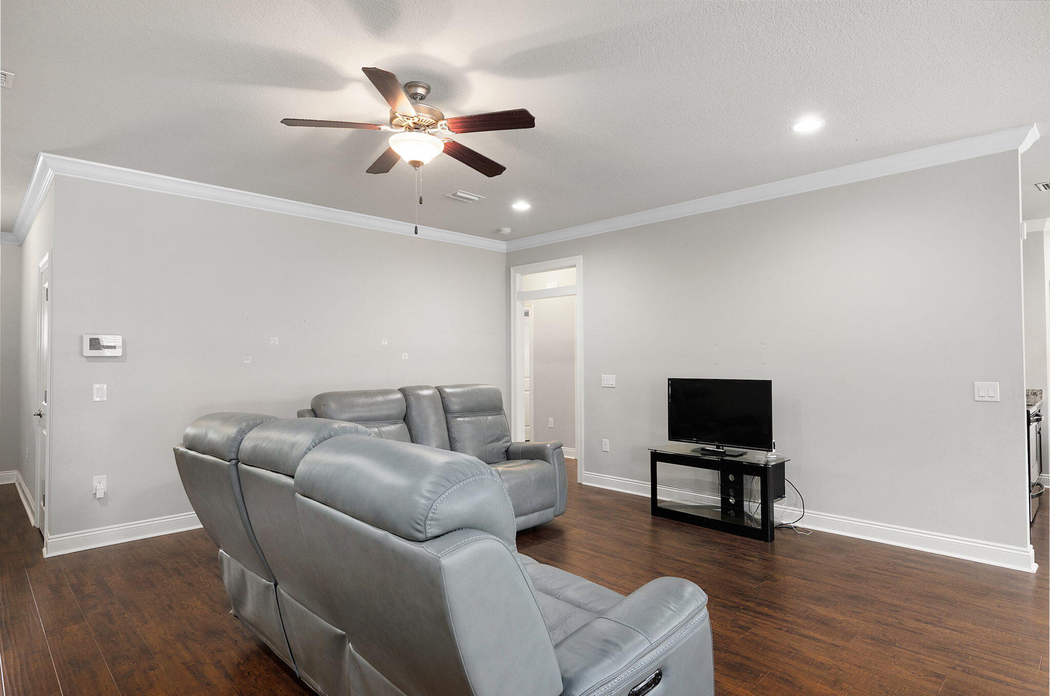 9018 Timber Lane Navarre, FL 32566 - Photo 5 of 39 a living room with furniture and a flat screen tv