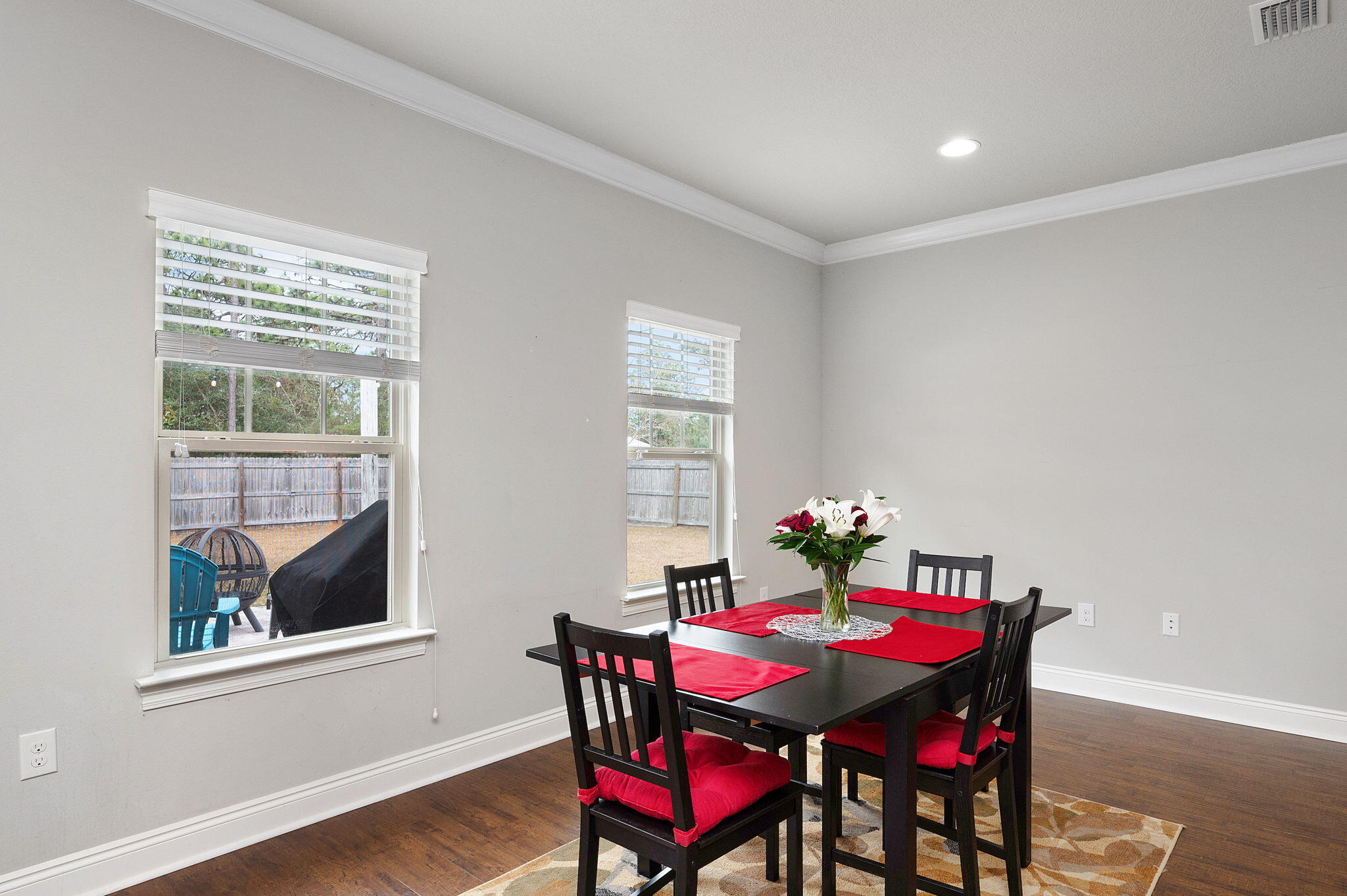 9018 Timber Lane Navarre, FL 32566 - Photo 7 of 39 a view of a dining room with furniture window and wooden floor