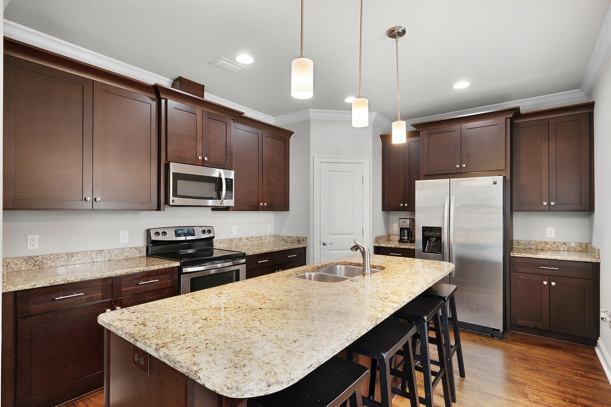 9018 Timber Lane Navarre, FL 32566 - Photo 9 of 39 a kitchen with stainless steel appliances granite countertop a sink a stove a refrigerator cabinets and chairs