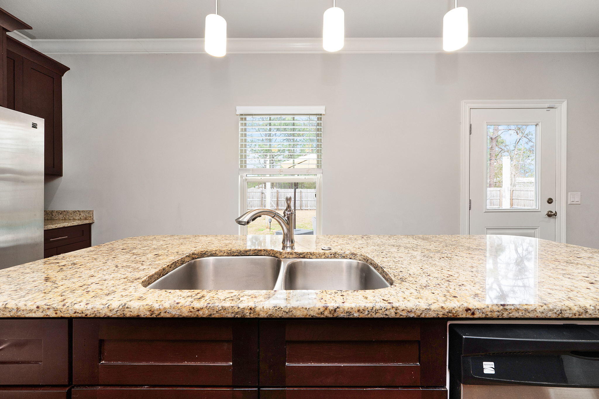 9018 Timber Lane Navarre, FL 32566 - Photo 10 of 39 a kitchen with granite countertop a sink and a granite counter tops