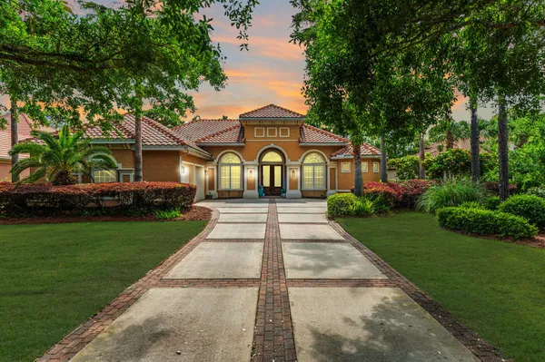a front view of a house with a garden