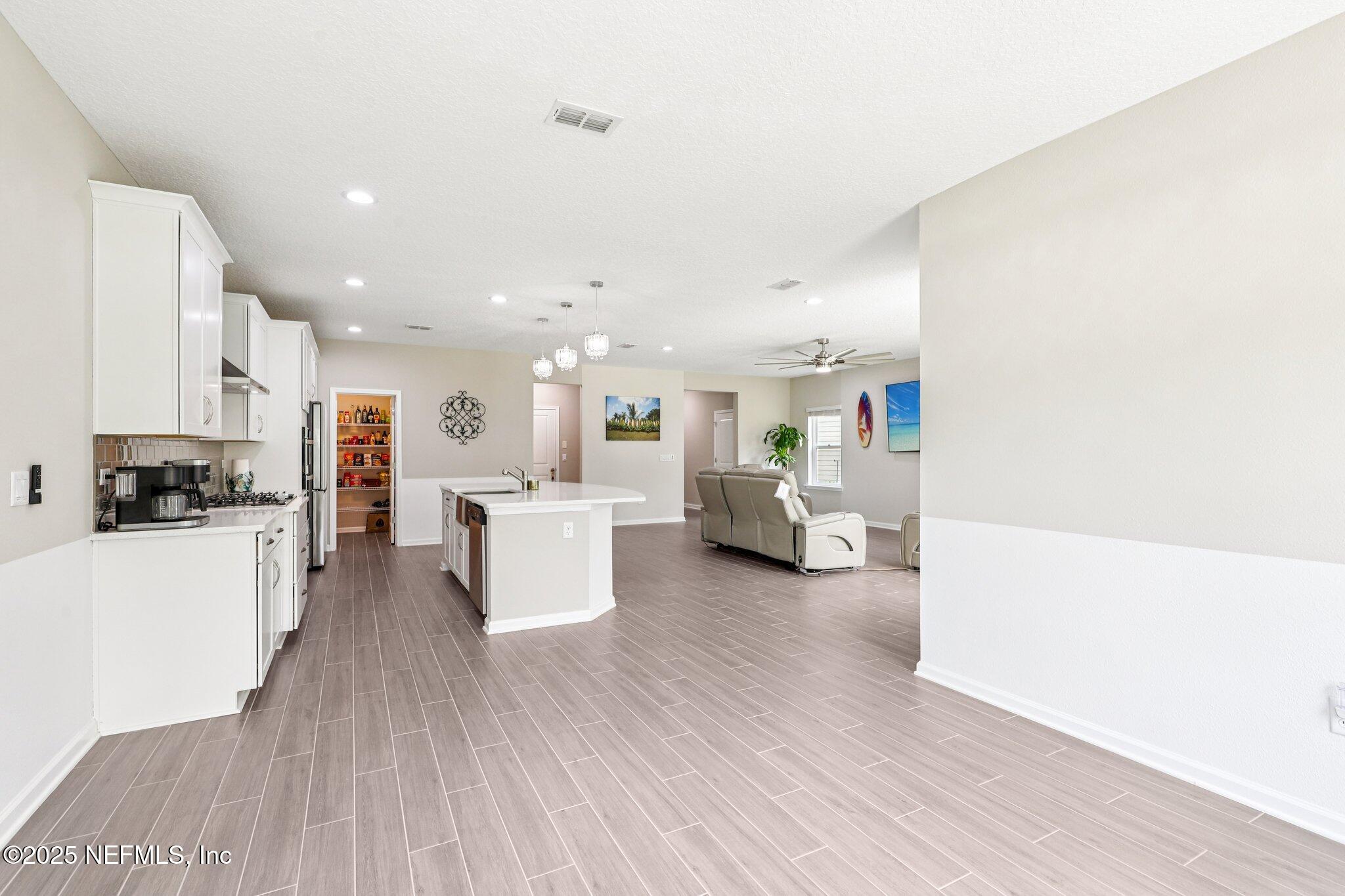456 Stargaze Lane St. Augustine, FL 32095 - Photo 12 of 40 a large white kitchen with lots of counter top space and refrigerator