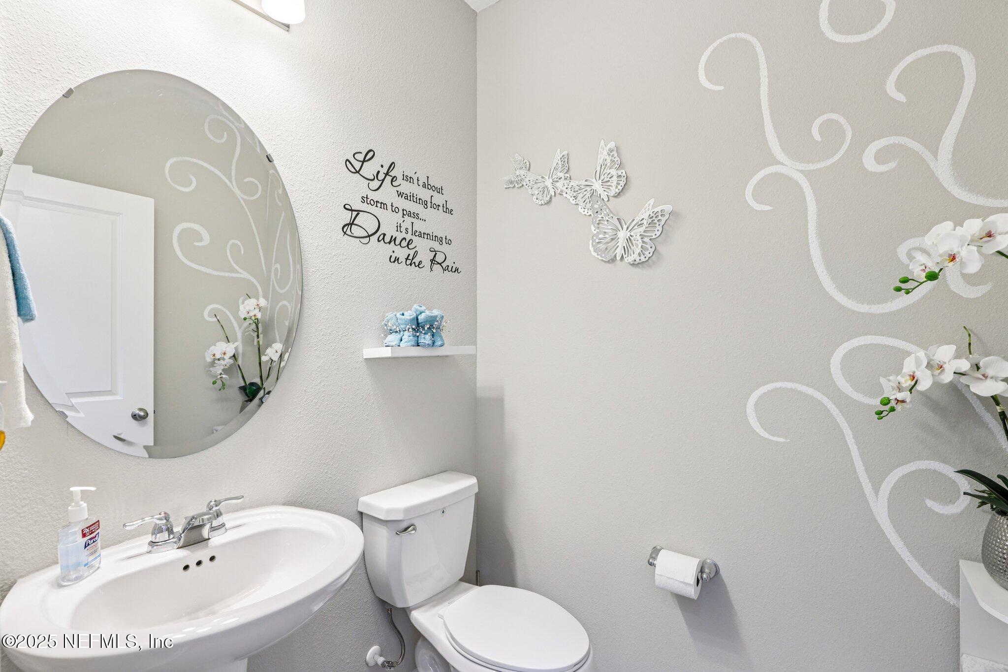 456 Stargaze Lane St. Augustine, FL 32095 - Photo 13 of 40 a bathroom with a toilet sink and mirror