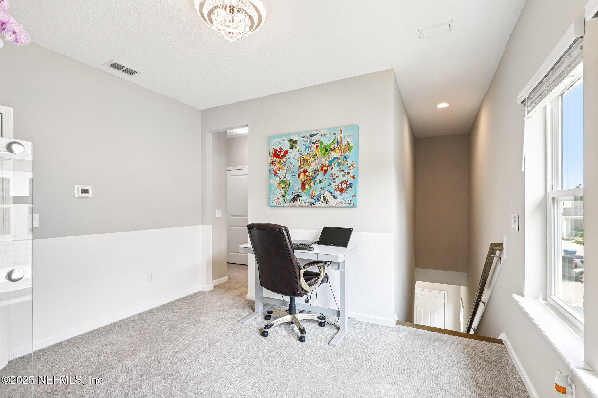 456 Stargaze Lane St. Augustine, FL 32095 - Photo 16 of 40 a view of a workspace with furniture and a window