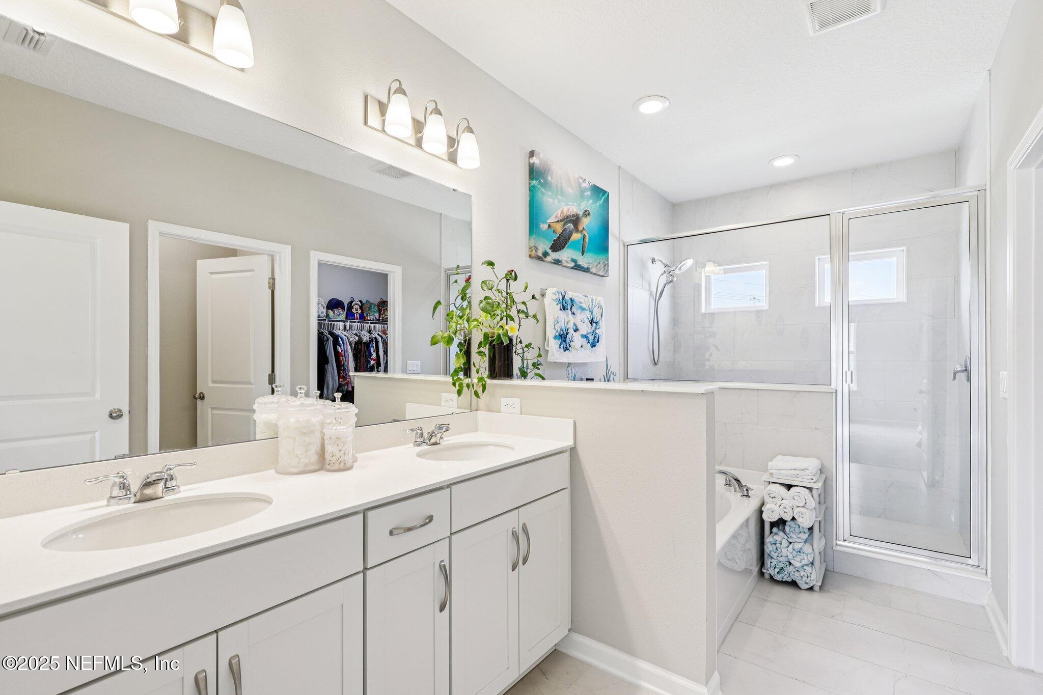 456 Stargaze Lane St. Augustine, FL 32095 - Photo 19 of 40 a bathroom with a double vanity sink and a mirror
