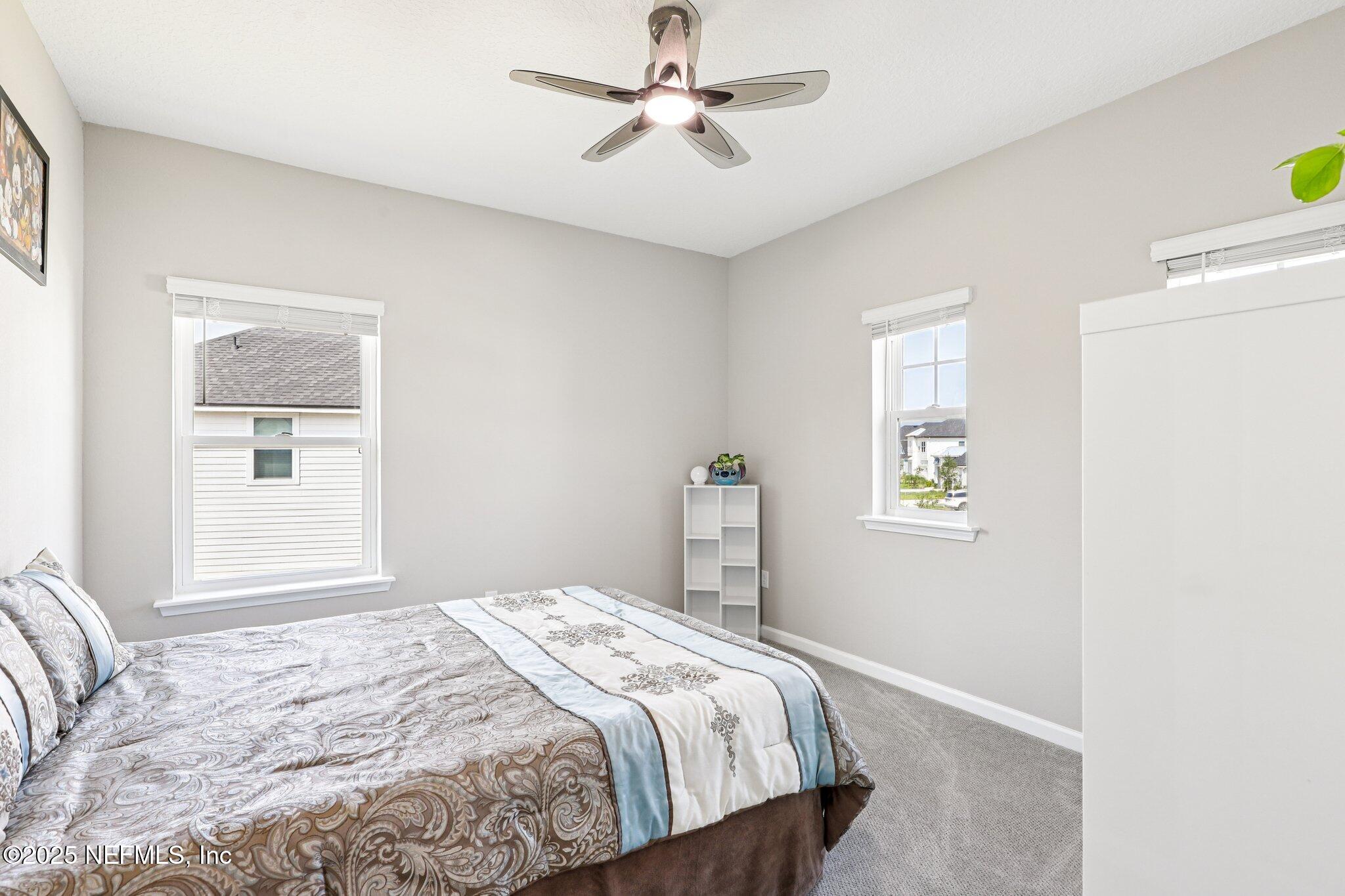 456 Stargaze Lane St. Augustine, FL 32095 - Photo 22 of 40 a bedroom with a bed and a window