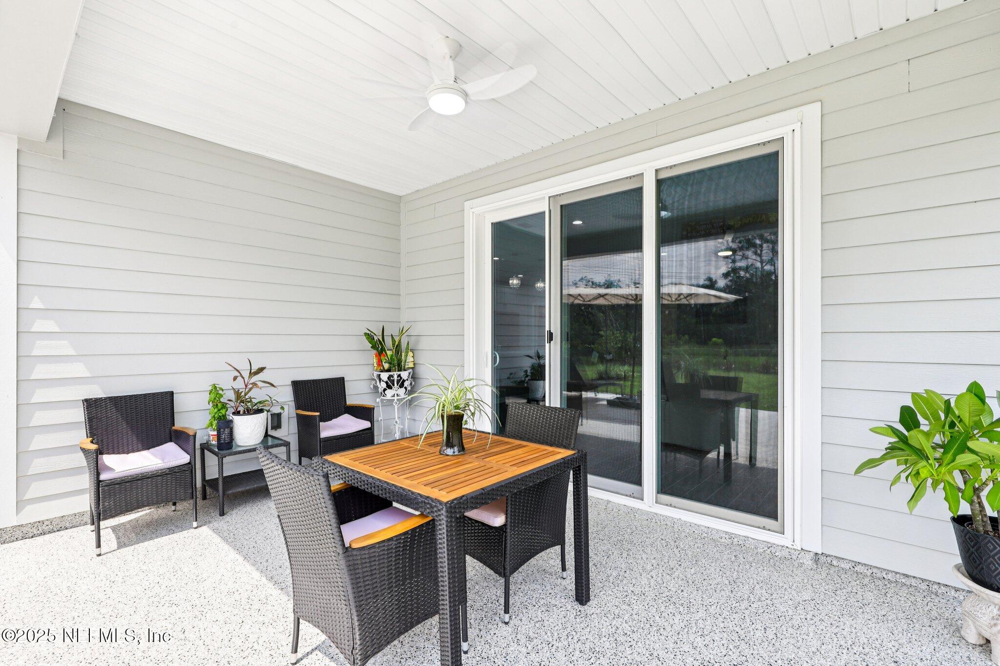 456 Stargaze Lane St. Augustine, FL 32095 - Photo 25 of 40 a living room with furniture table and a potted plant