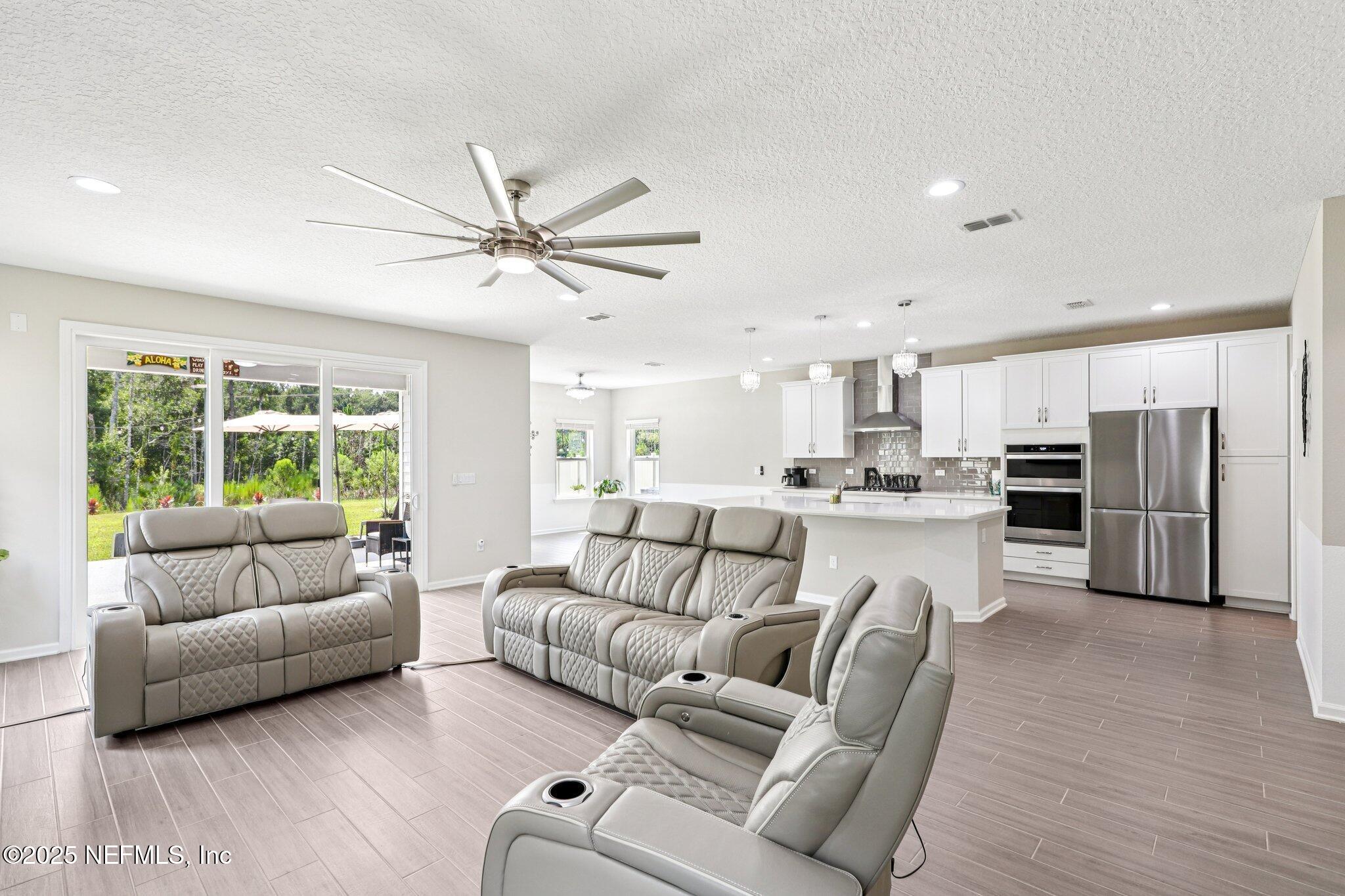 456 Stargaze Lane St. Augustine, FL 32095 - Photo 3 of 40 a living room with furniture and kitchen view