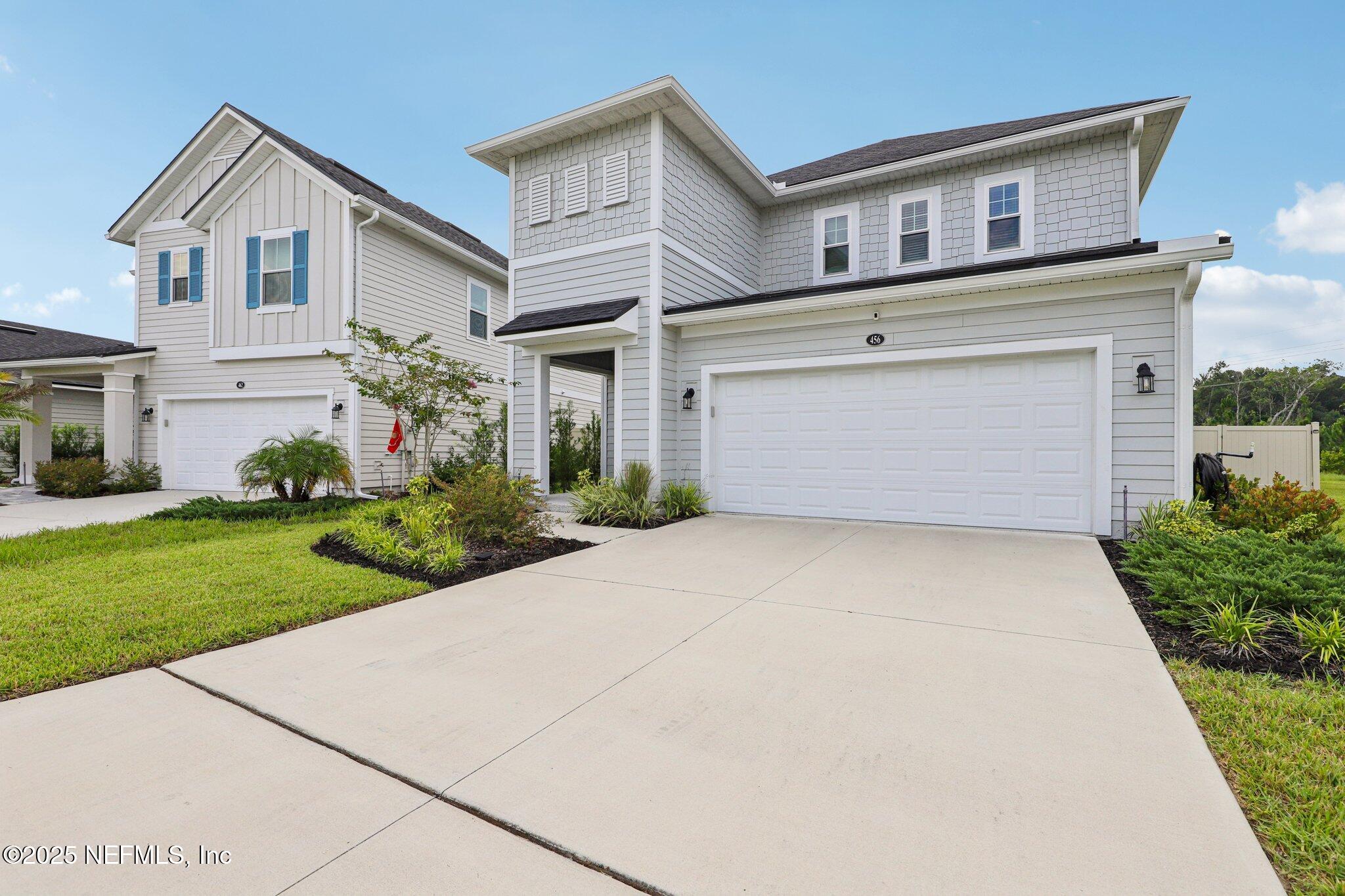 456 Stargaze Lane St. Augustine, FL 32095 - Photo 31 of 40 a front view of a house with a yard and garage