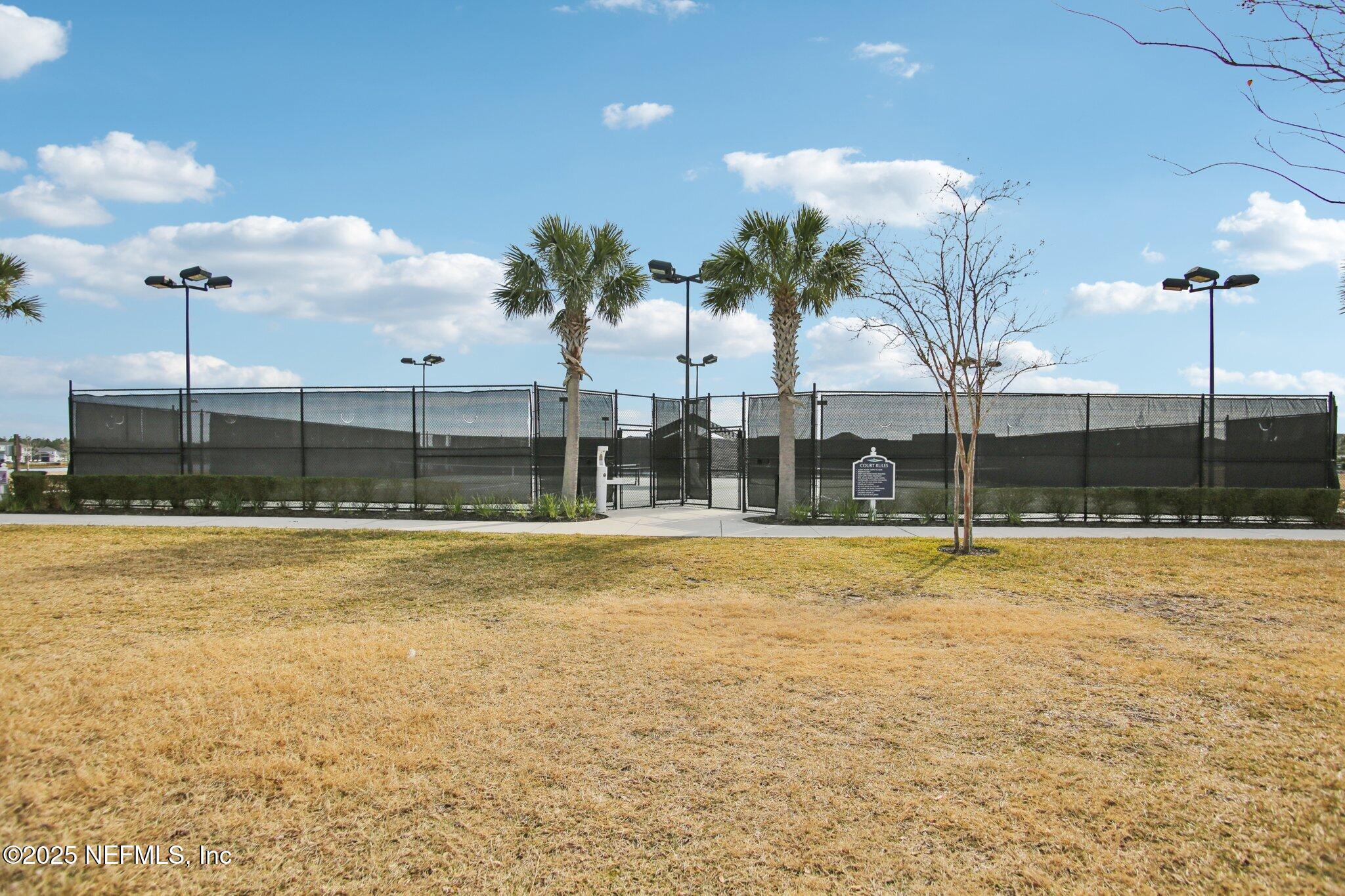 456 Stargaze Lane St. Augustine, FL 32095 - Photo 38 of 40 a view of a swimming pool with a lawn chairs under an umbrella