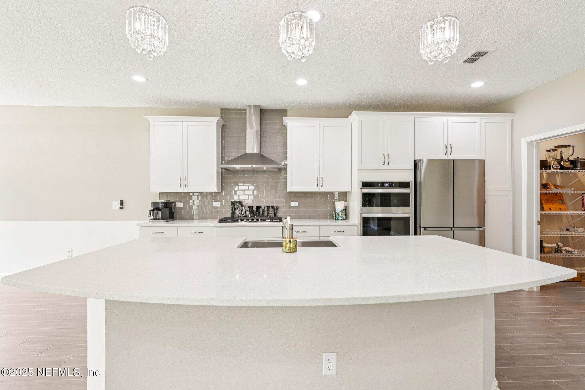 456 Stargaze Lane St. Augustine, FL 32095 - Photo 7 of 40 a kitchen with stainless steel appliances a sink stove and refrigerator
