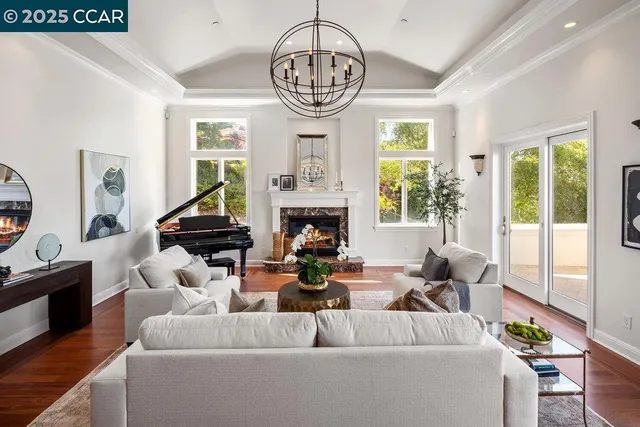 a living room with fireplace furniture and a large window
