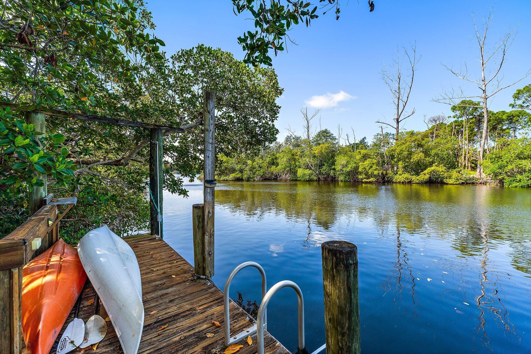 702 Warren Drive Jupiter, FL 33458 - Photo 30 of 76 a view of a lake with couches chairs