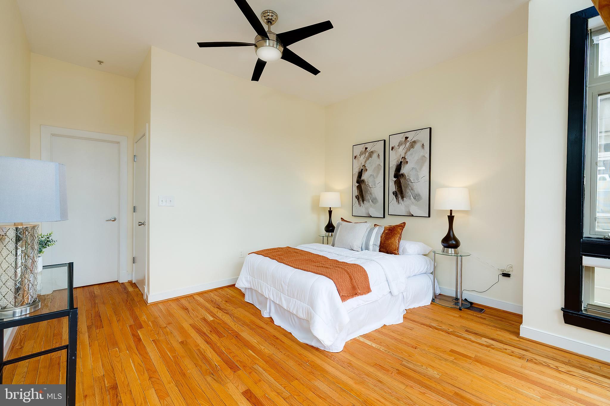 2363 Champlain Street Northwest, Unit 20 Washington, DC 20009 - Photo 13 of 29 a bedroom with a bed and wooden floor