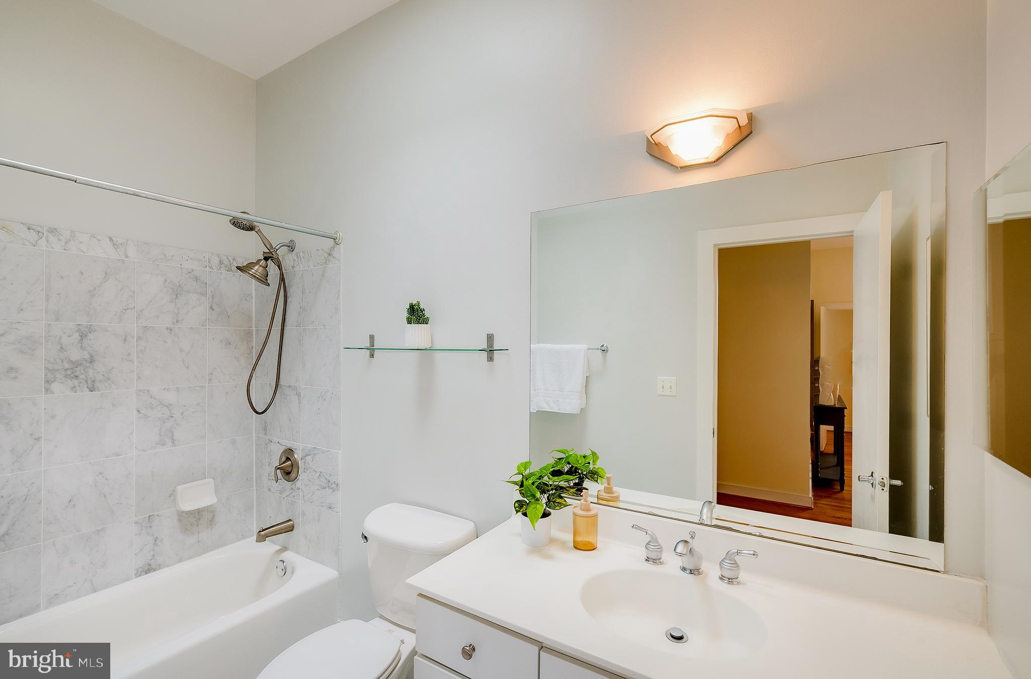 2363 Champlain Street Northwest, Unit 20 Washington, DC 20009 - Photo 19 of 29 a bathroom with a sink mirror toilet and bathtub
