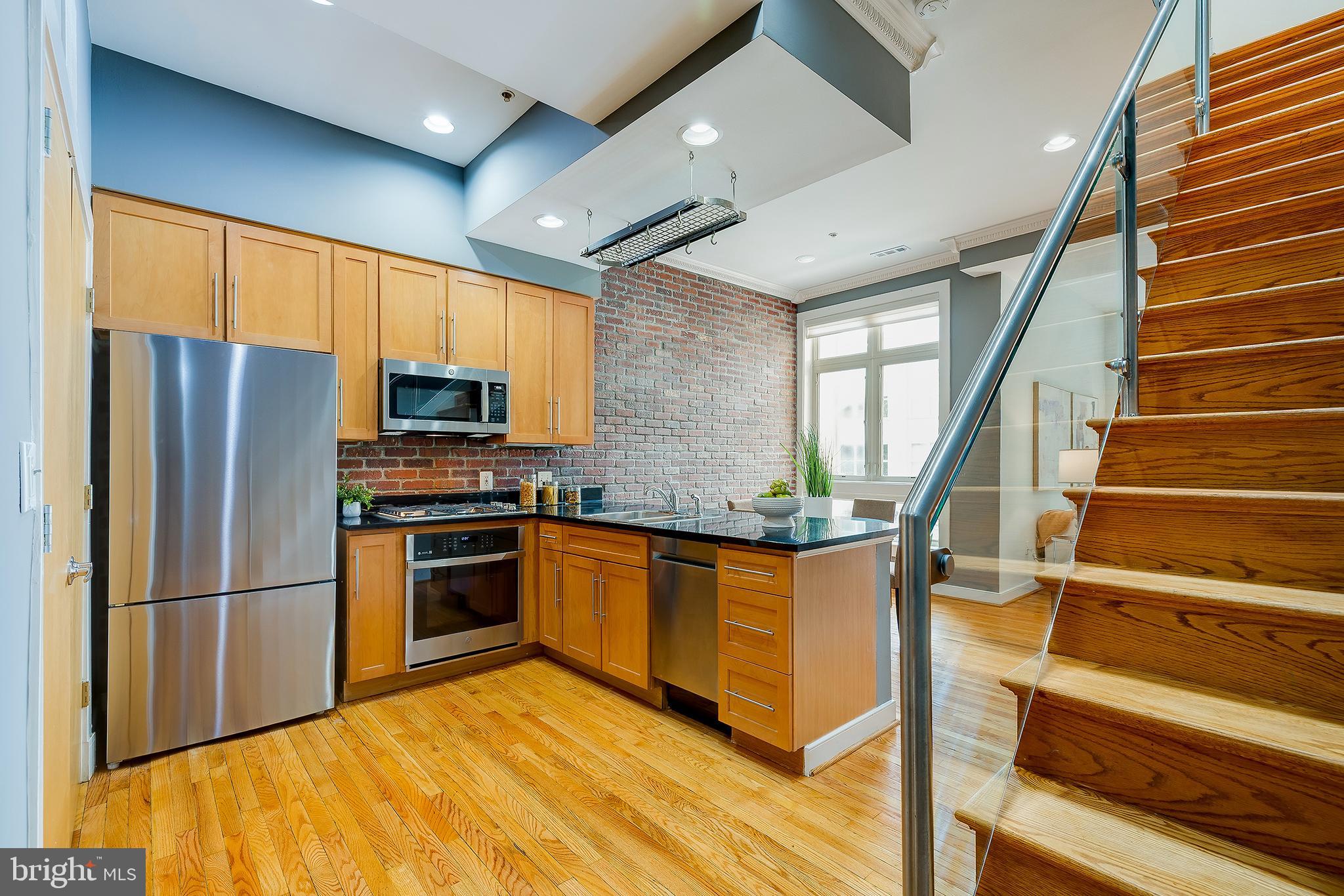2363 Champlain Street Northwest, Unit 20 Washington, DC 20009 - Photo 3 of 29 a kitchen with stainless steel appliances granite countertop a refrigerator a stove and a sink with cabinets