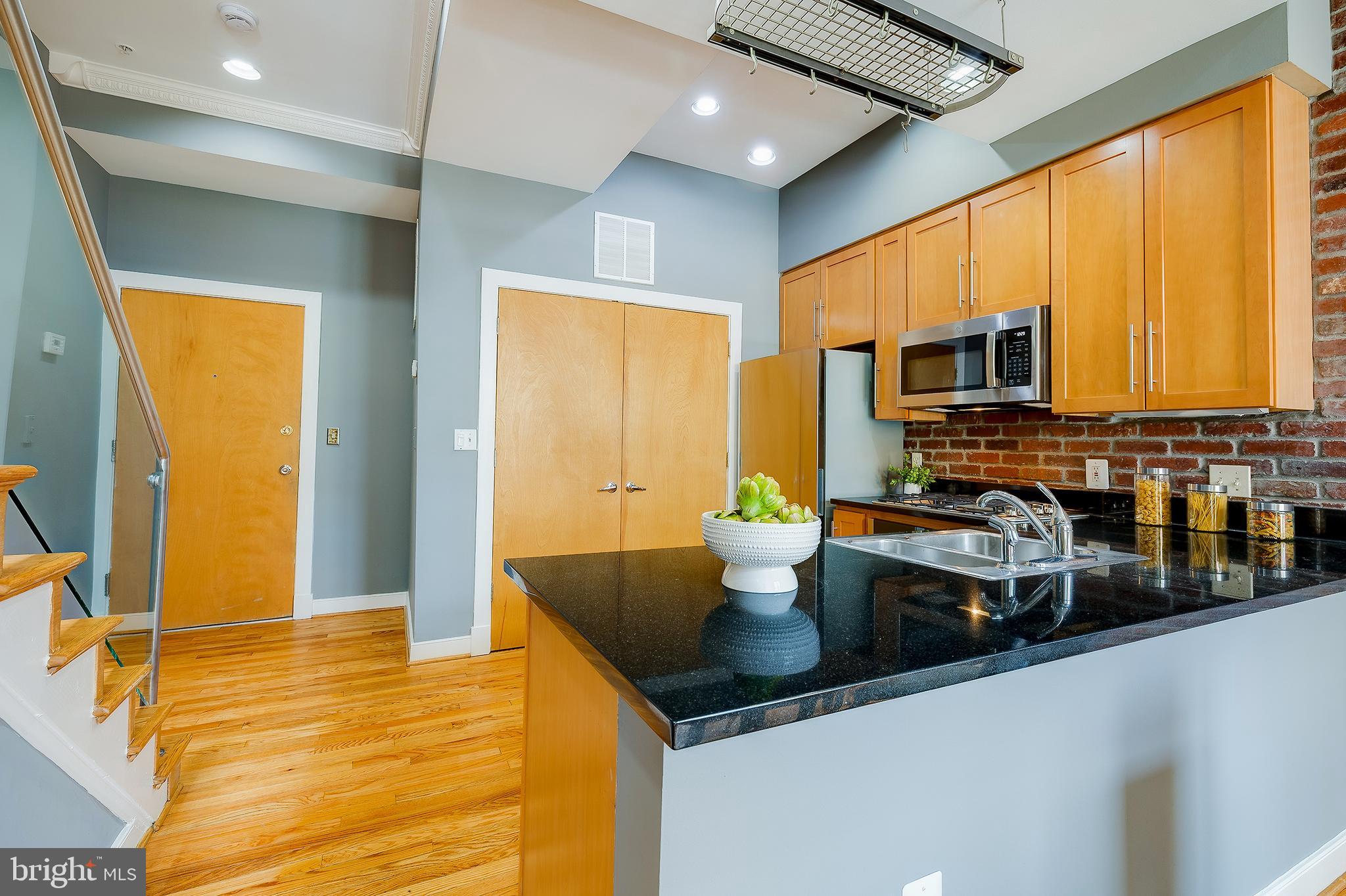 2363 Champlain Street Northwest, Unit 20 Washington, DC 20009 - Photo 4 of 29 a kitchen with a sink a stove and a microwave
