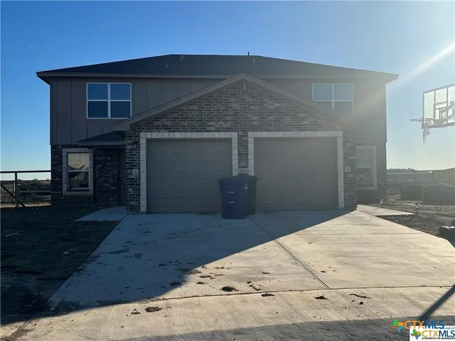 a living room with granite countertop furniture and a flat screen tv