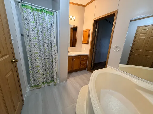 a bathroom with a tub sink and mirror