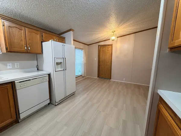 a view of a kitchen with refrigerator and a stove