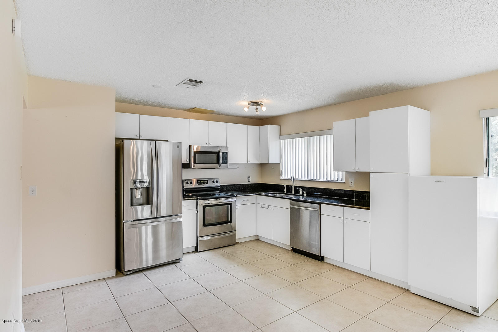 639 Furth Road Northwest Palm Bay, FL 32907 - Photo 15 of 22 a kitchen with stainless steel appliances granite countertop a refrigerator and a stove top oven